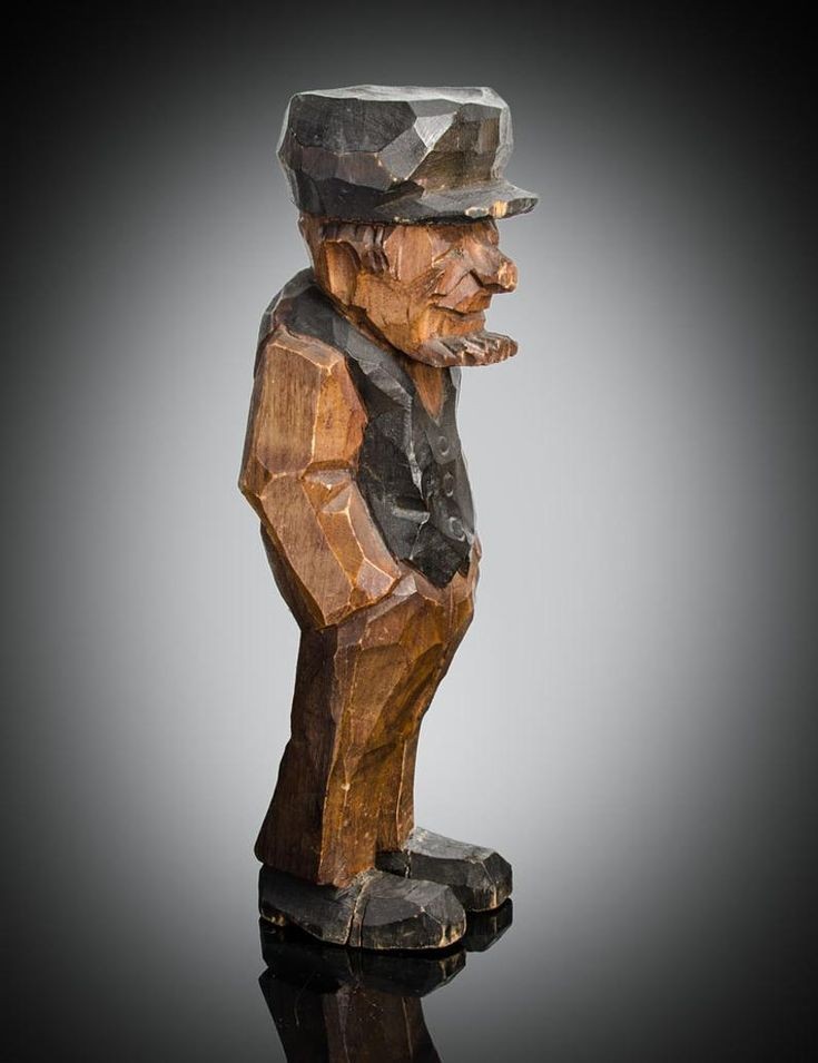 A rough carved wooden gnome