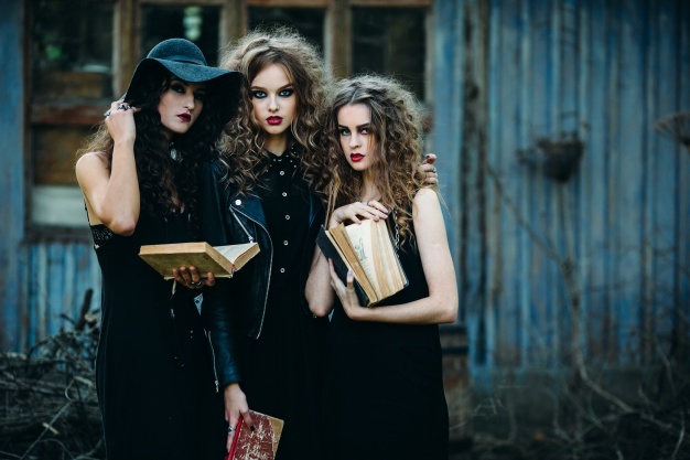 girls-disguised-as-witches-holding-old-books-hands_1153-2019.jpg
